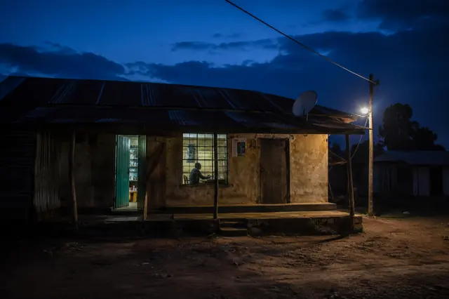 A lit window at blue hour