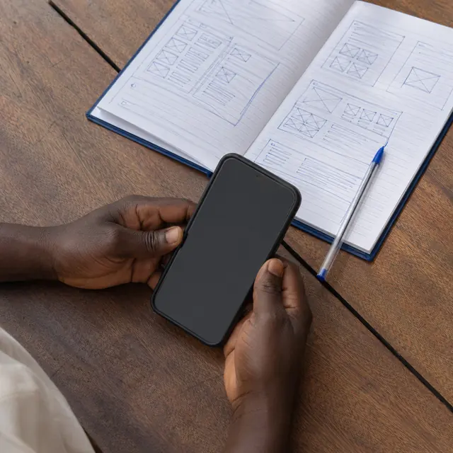 A phone and a wireframe notebook